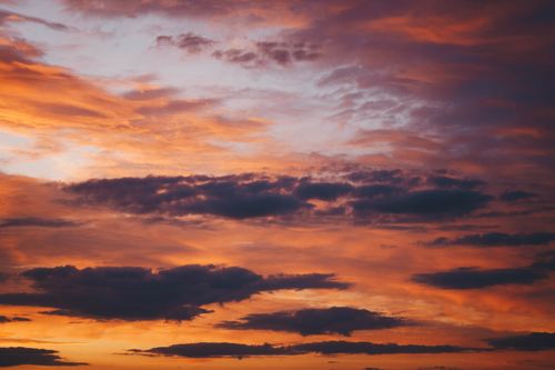 Free Stunning sunset sky filled with vibrant colors and dramatic clouds, capturing the tranquility of nature. Stock Photo