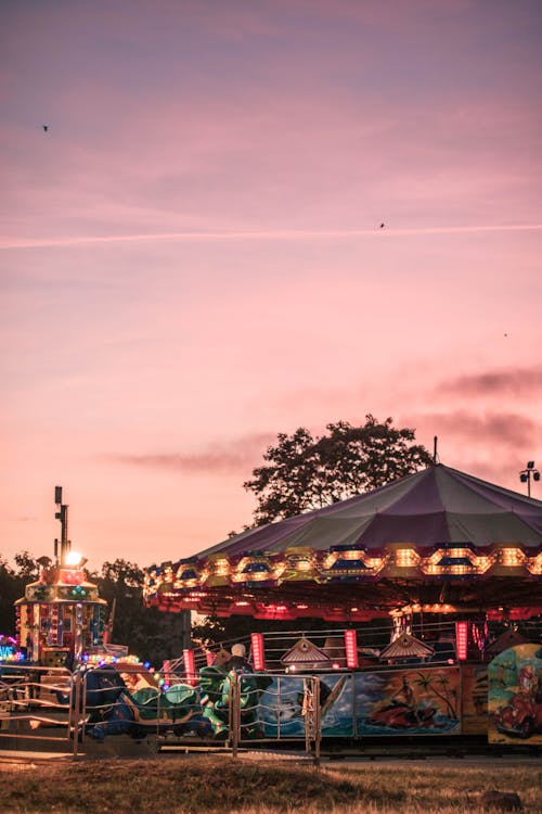 Carousel in amusement park during sunset