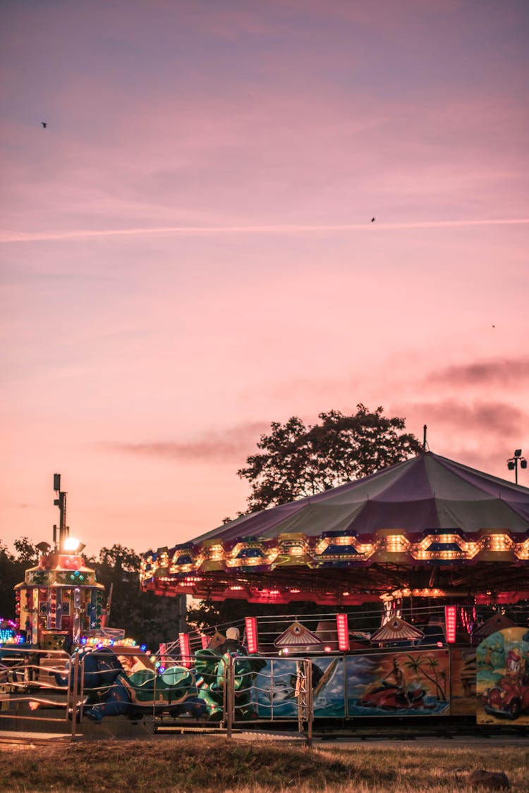 Carousel In Amusement Park During Sunset