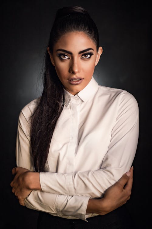 Close-Up Shot of an Attractive Woman in White Long Sleeves Posing