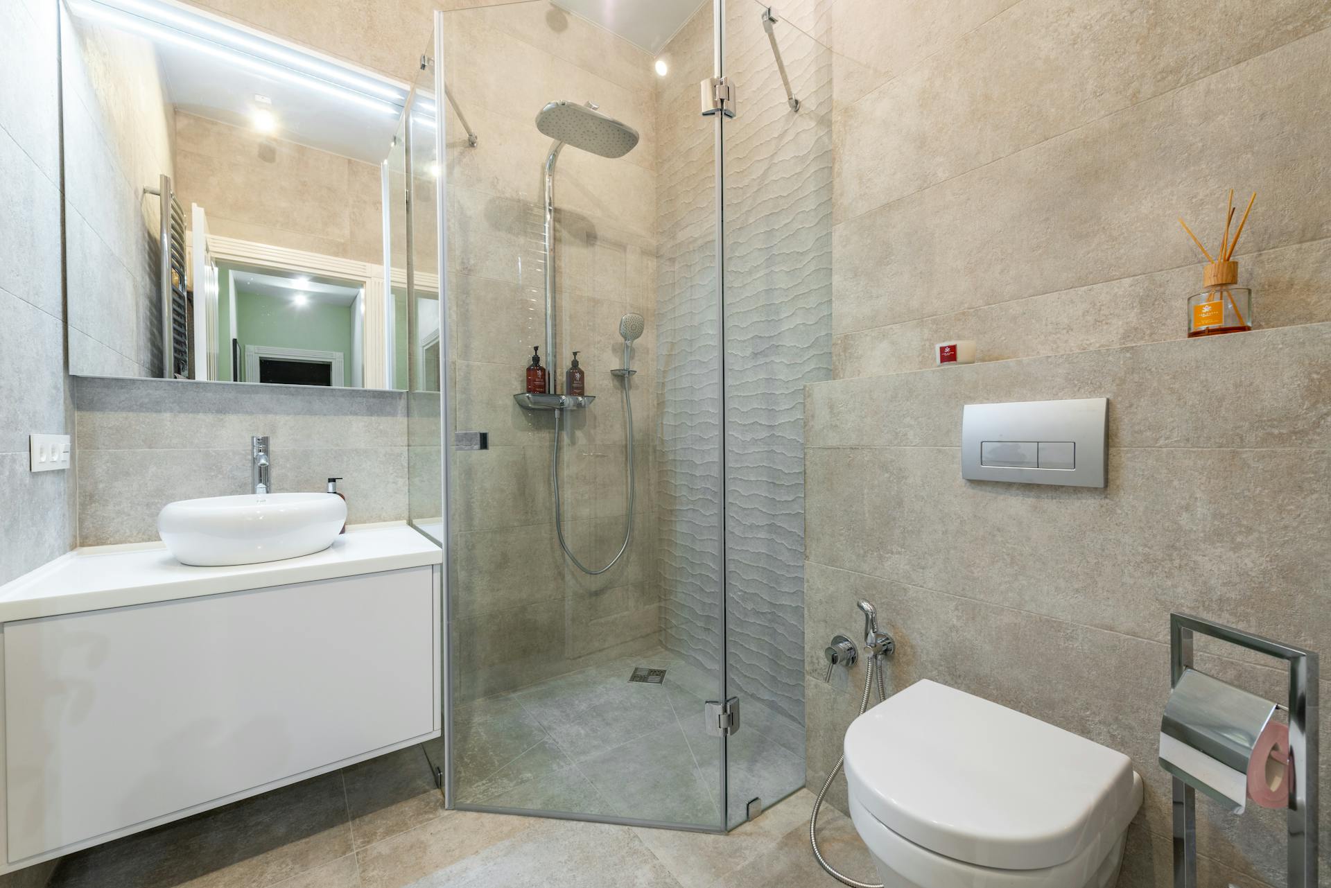 Modern bathroom interior with shower cabin and mirror in house