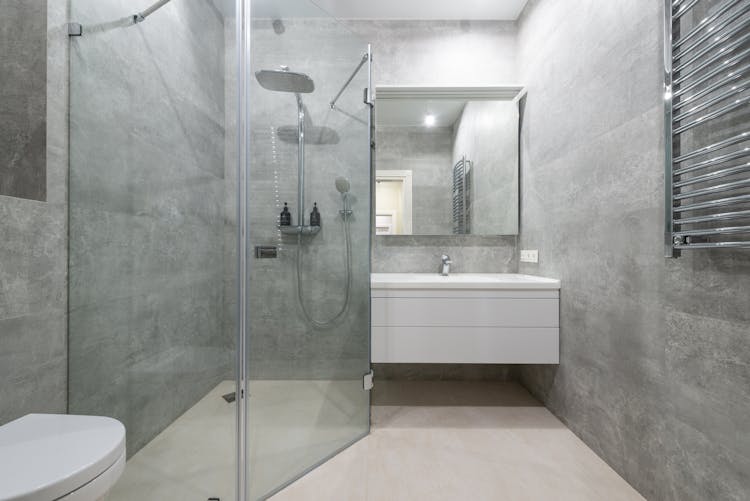 Modern Shower Room Interior With Glass Walls Against Washstand