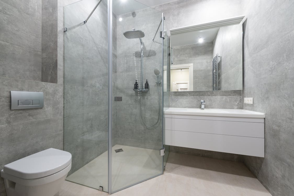 Modern bathroom interior with shower cabin and washbasin at home
