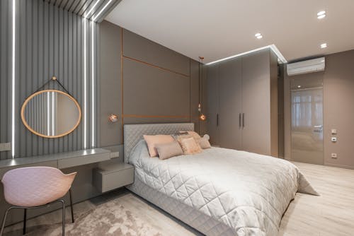 Contemporary bedroom interior with furniture and lamps in house