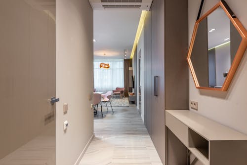 Free Stylish corridor interior of contemporary light flat leading to light spacious living room Stock Photo