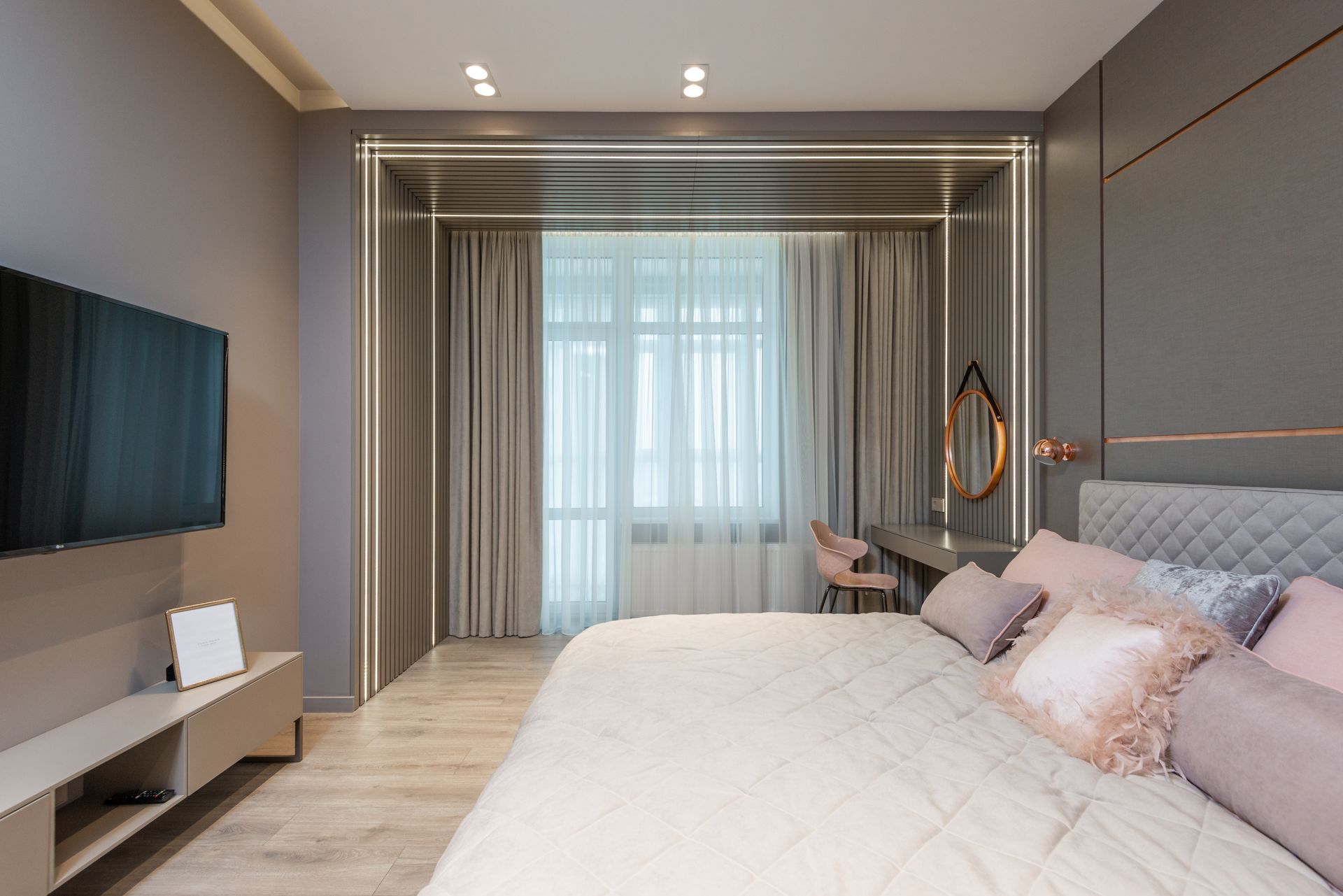Modern bedroom interior design with soft king size bed with cozy pillows and TV set