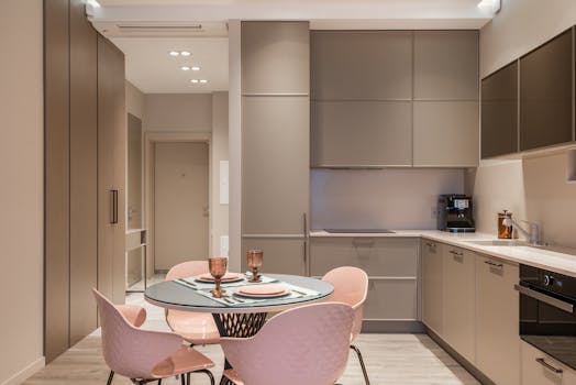 Stylish modern kitchen with minimalist design featuring sleek cabinetry and contemporary dining area.
