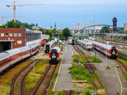 Free Aerial view of a train yard in Berlin with multiple trains on the tracks, surrounded by cityscape. Stock Photo