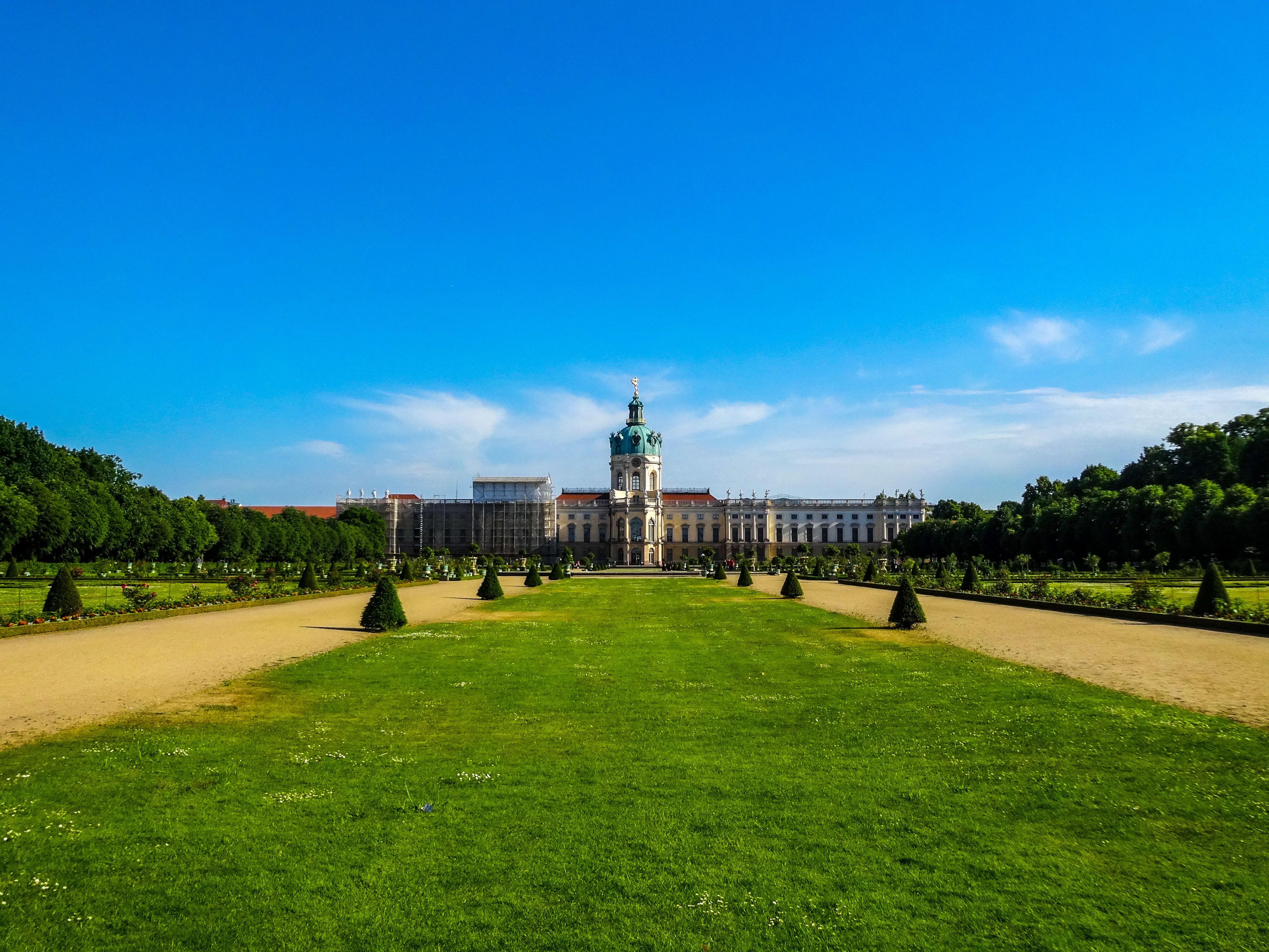 Stunning view of Charlottenburg Palace and gardens on a bright summer day, perfect travel destination.
