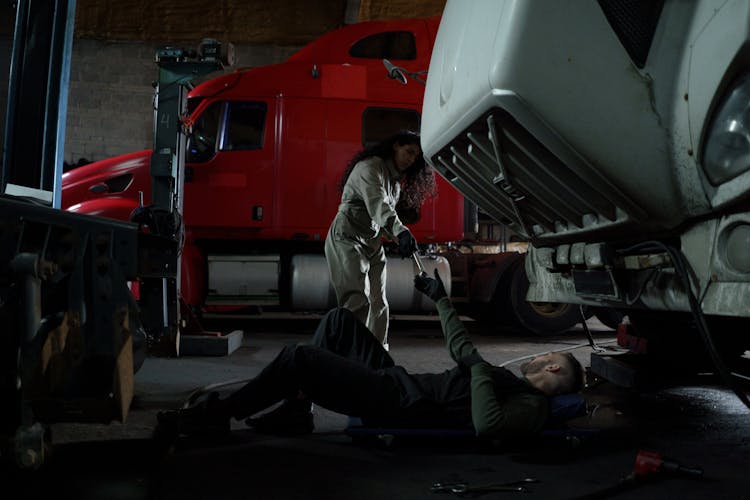 Man Working While Lying Under A Truck