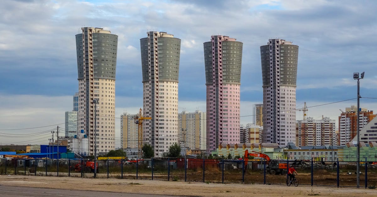 Modern high-rise buildings in Moscow with a cloudy sky backdrop and urban landscape.