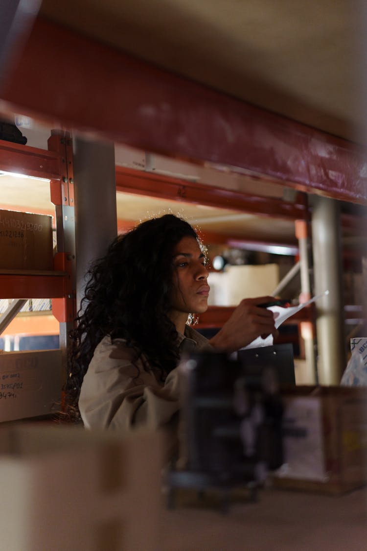 Woman Holding A Paper Inside The Warehouse