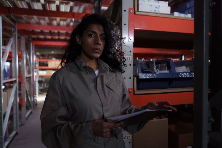 Woman Wearing Grey Uniform In Warehouse