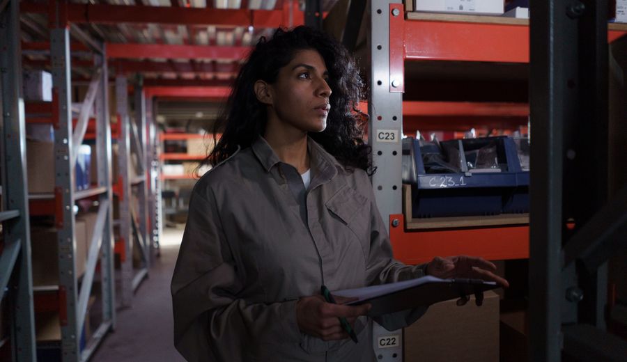 Warehouse worker checking inventory against a list
