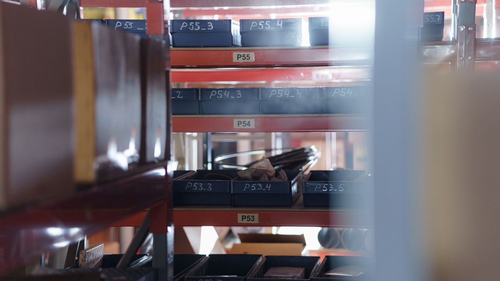 A well-organized warehouse shelving unit with numbered bins for efficient storage and inventory management.