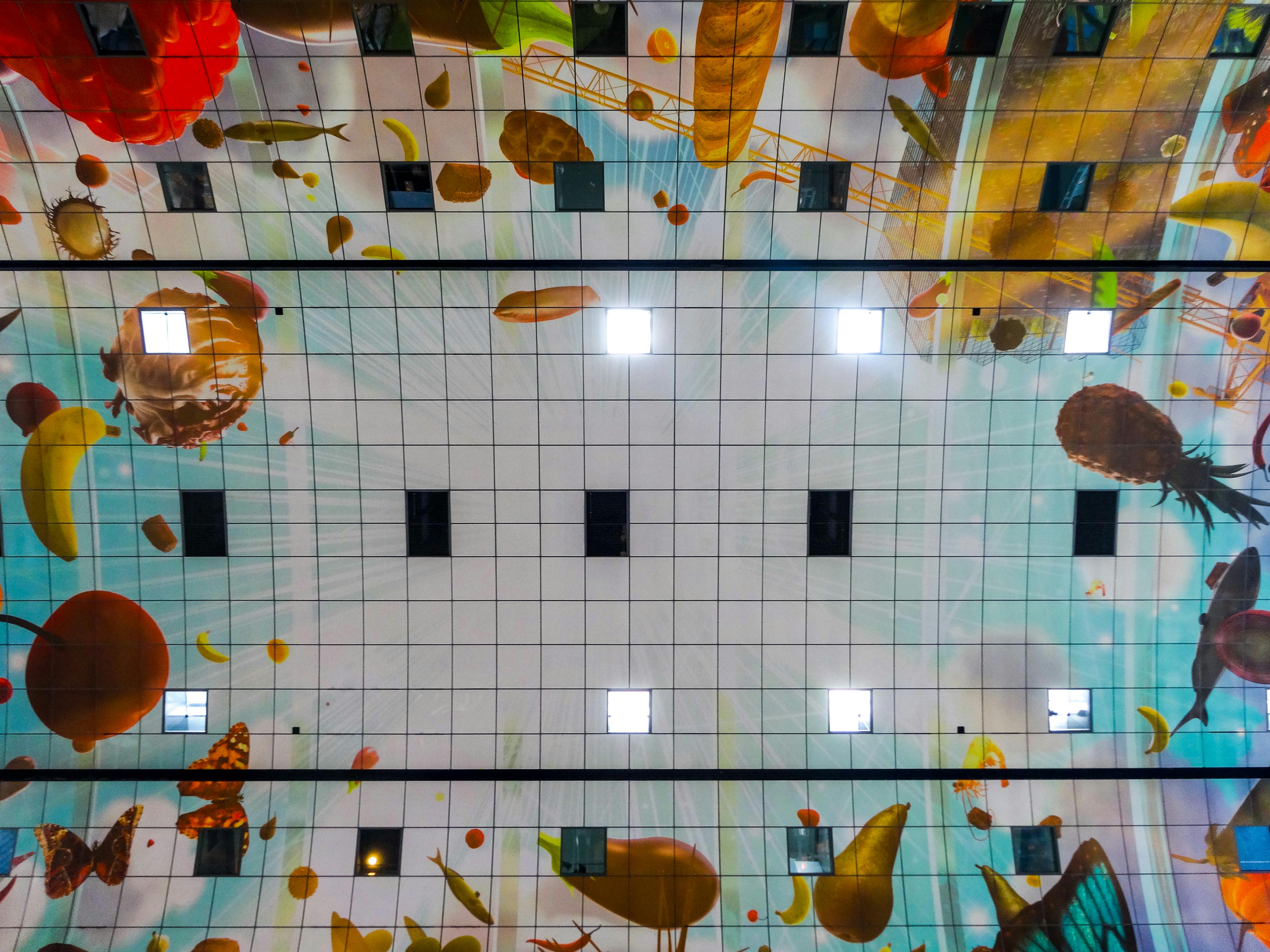 Glamorous woman in a sparkly dress standing by a decorated Christmas tree