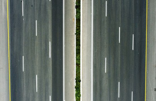 Top-down aerial view of a highway with green median in Petach Tikva, Israel.