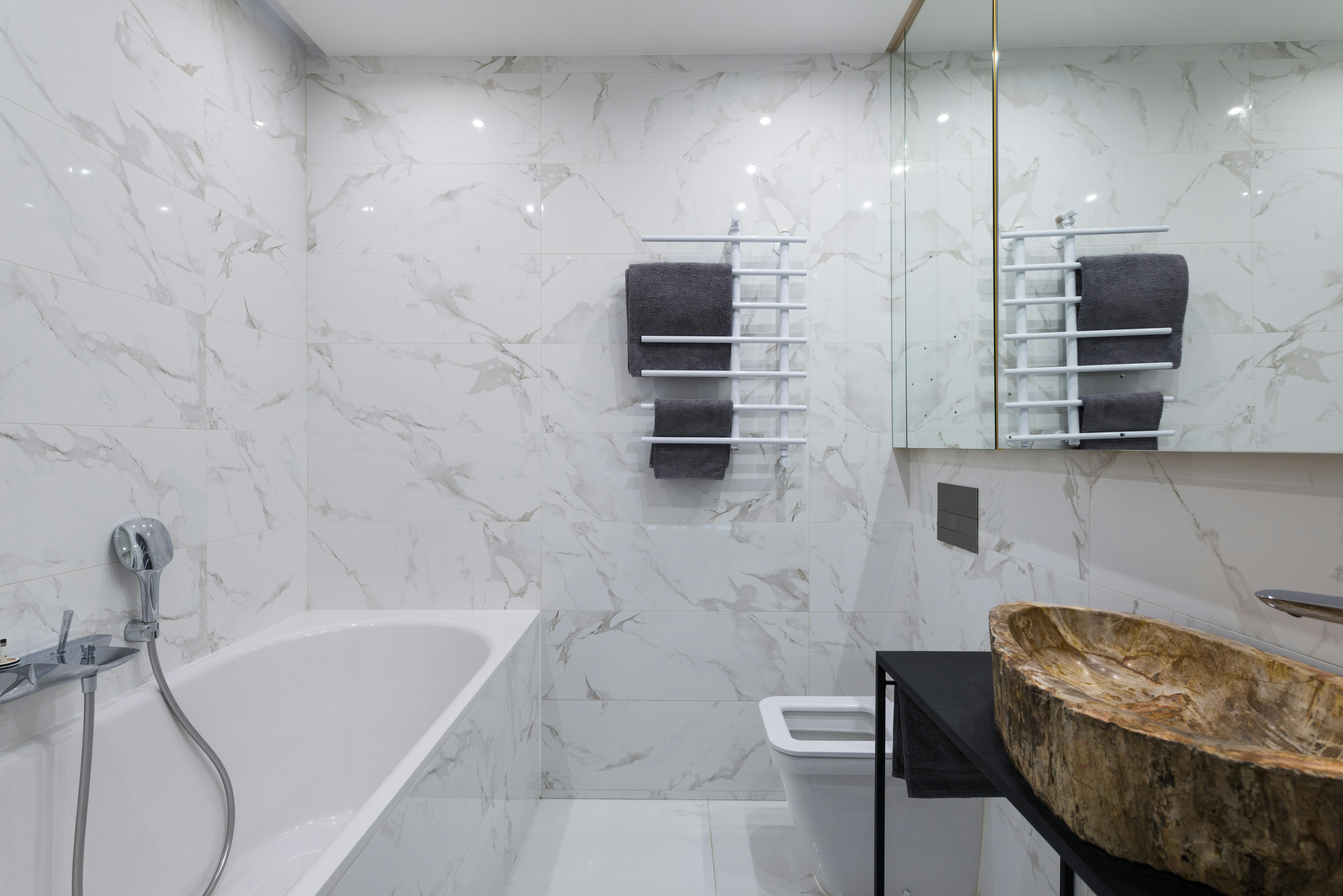 light bathroom with bathtub and stylish sink