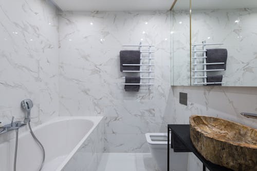 Light bathroom with bathtub and stylish sink