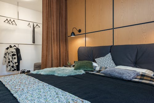 Interior of bedroom with clothes hanging on hangers