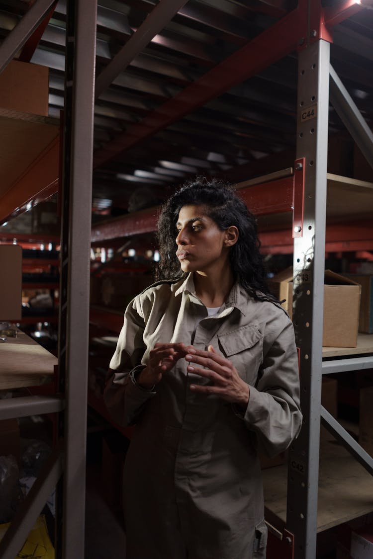 A Woman Standing In The Warehouse 