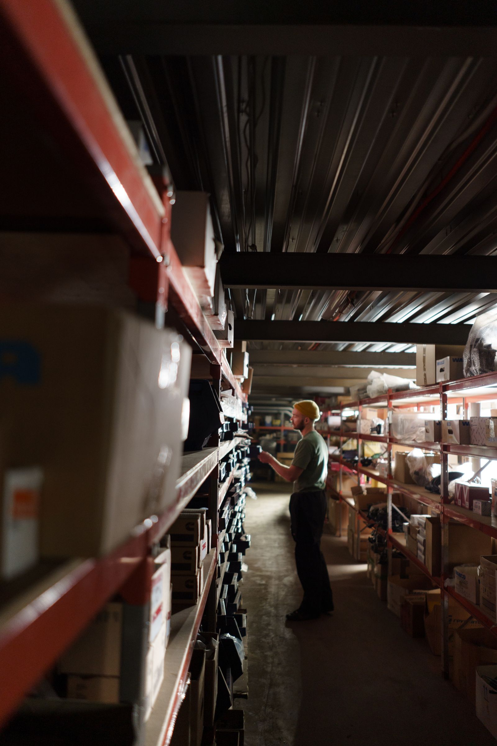 Worker checking stocked shelves in a warehouse