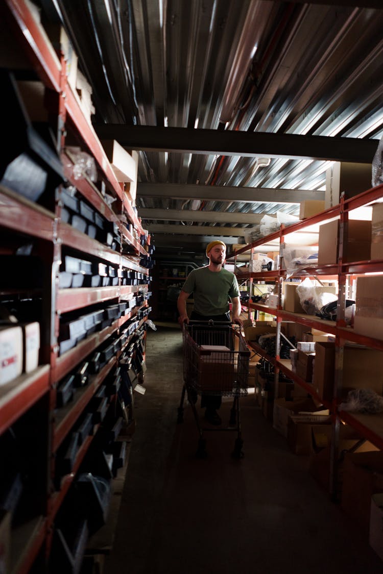 Man Walking On The Aisle In The Storage