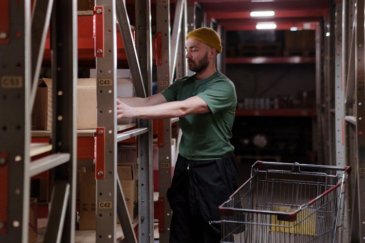 Man In Green Crew Neck T-shirt Working In The Warehouse