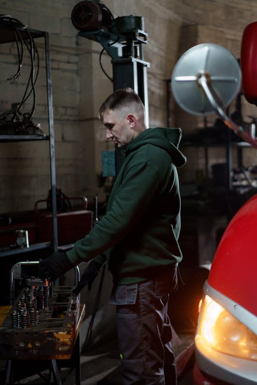 Free Male Auto Mechanic working on Car Shop  Stock Photo