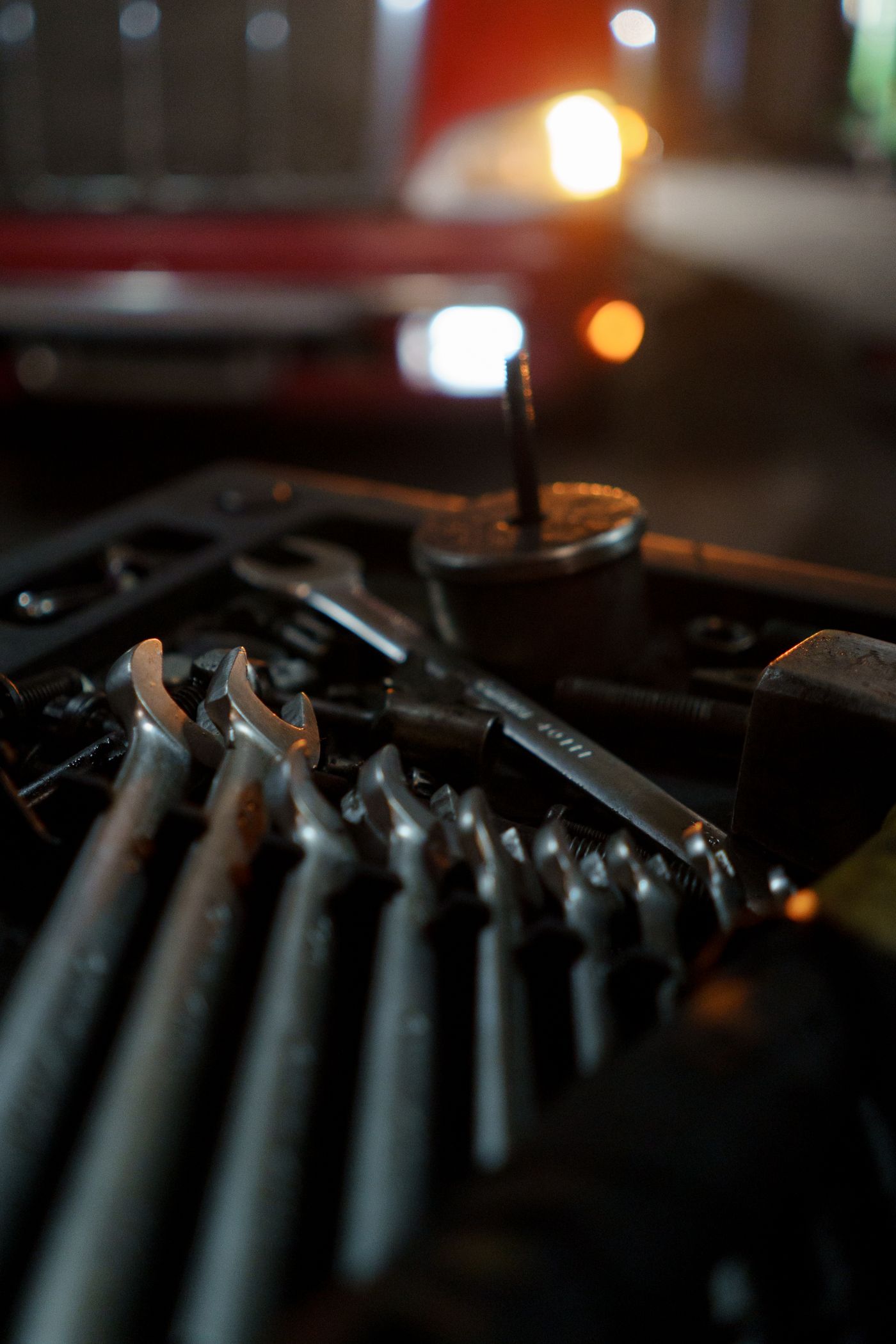 Automotive wrenches and hand tools arranged in a workshop