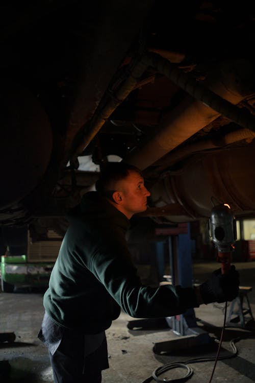 Auto Mechanic working on Car Shop