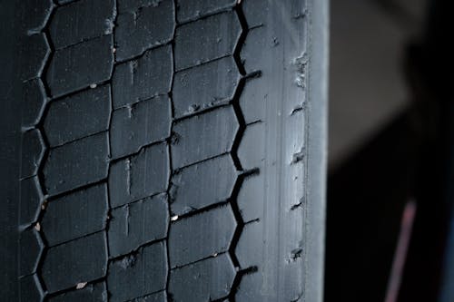 Free A Close-up Photography of a Tire with Pebbles in Treads Stock Photo