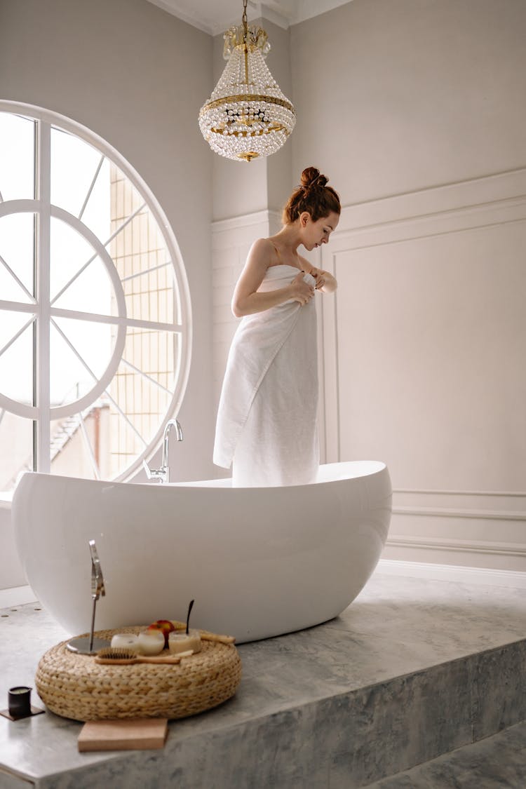 A Woman Standing In A Bathtub