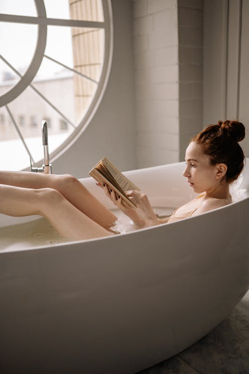 Woman Reading a Book in the Bathtub
