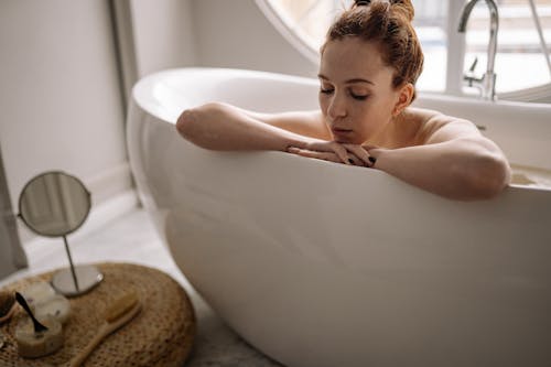 A Woman Sitting on Bathtub