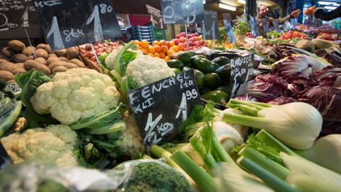 A vibrant display of fresh vegetables at a local market stall, showcasing a variety of produce.