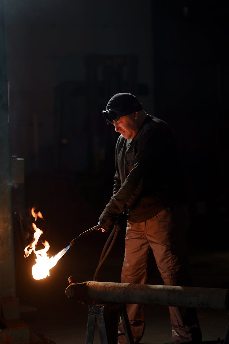 A Man Holding A Blow Torch