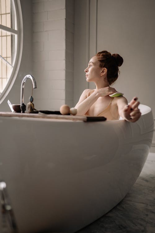 Woman in Bathtub Applying Soup