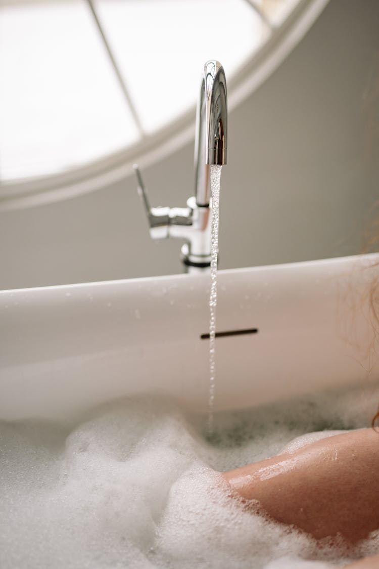 Water Dripping On White Ceramic Bathtub