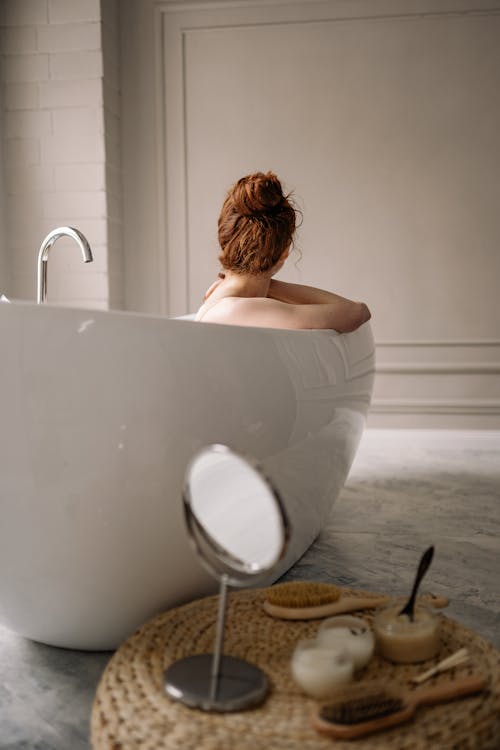 Free Woman in Bathtub With White Ceramic Sink Stock Photo