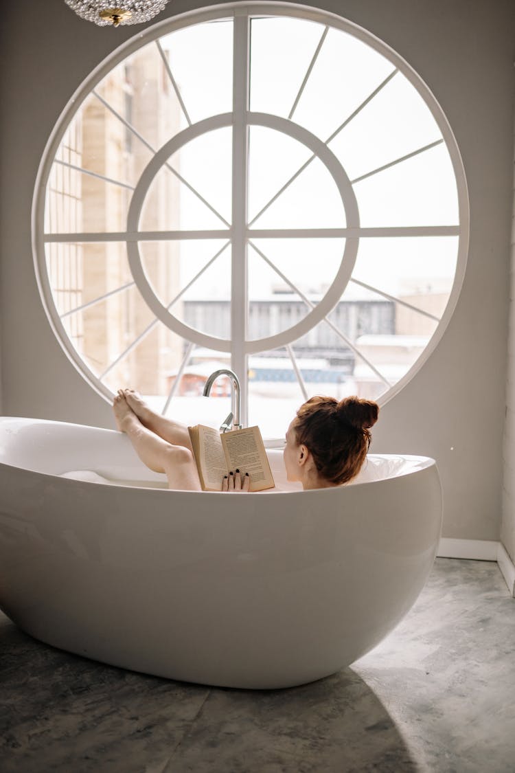 Woman In Bathtub Reading A Book