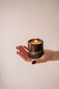 Person Holding Black Candle Holder