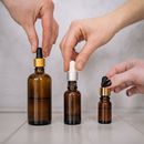 Photo of People's Hands Holding Droppers