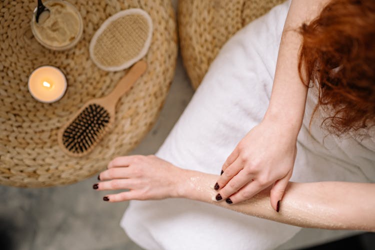 Woman Applying Scrub On Her Hands