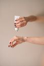 Photo of a Person's Hands Applying Lotion on Her Hand