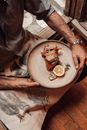 Crop man with delicious sandwiches and lemon slice on plate