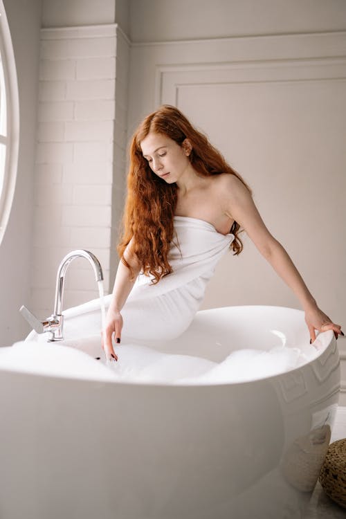 Free Woman Sitting on White Bathtub Stock Photo