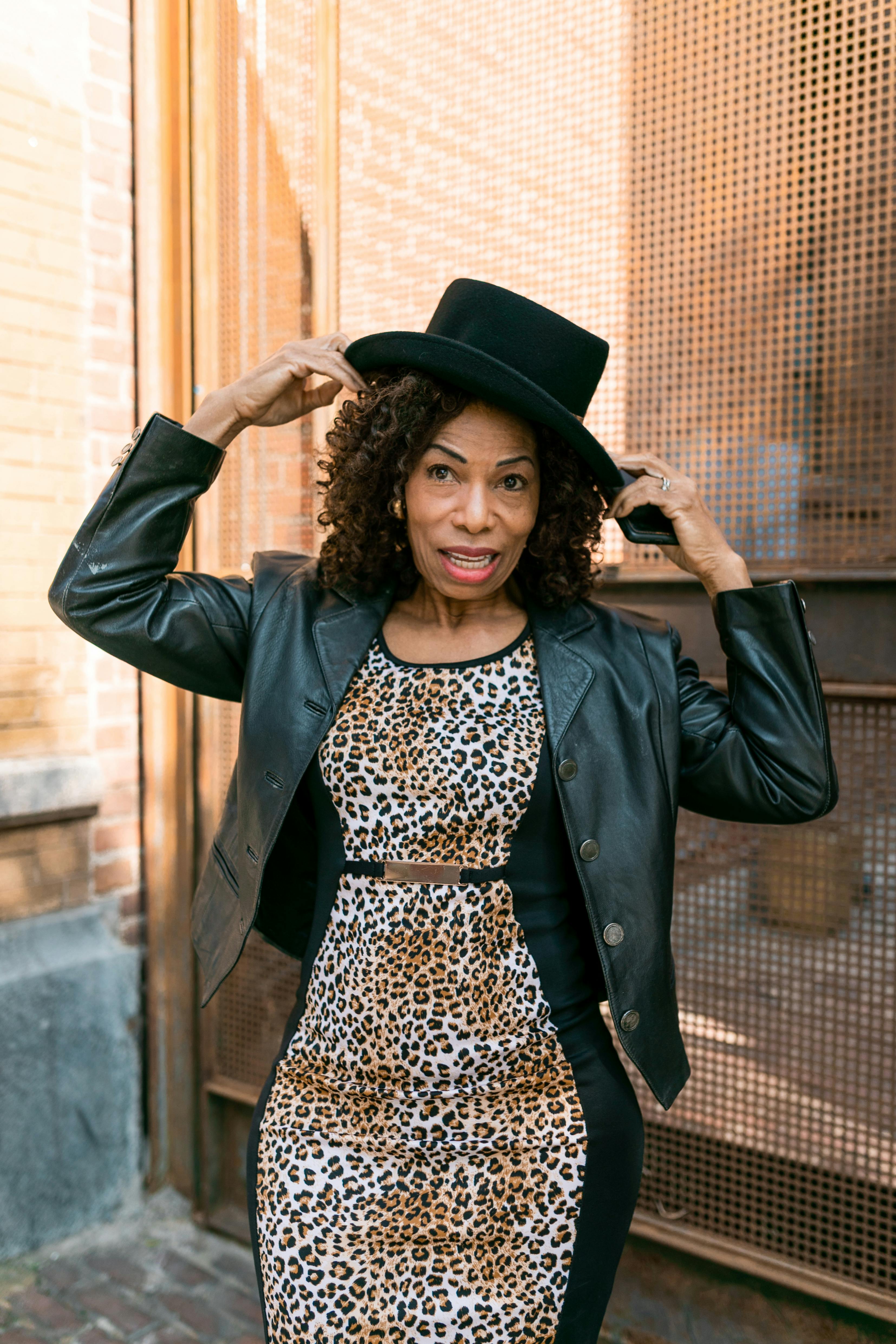 woman in black leather jacket with black hat