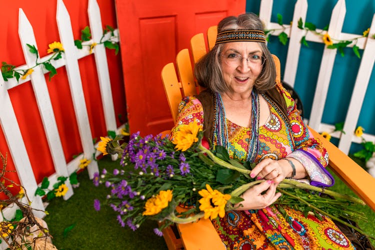 Groovy Woman Holding A Bunch Of Flowers