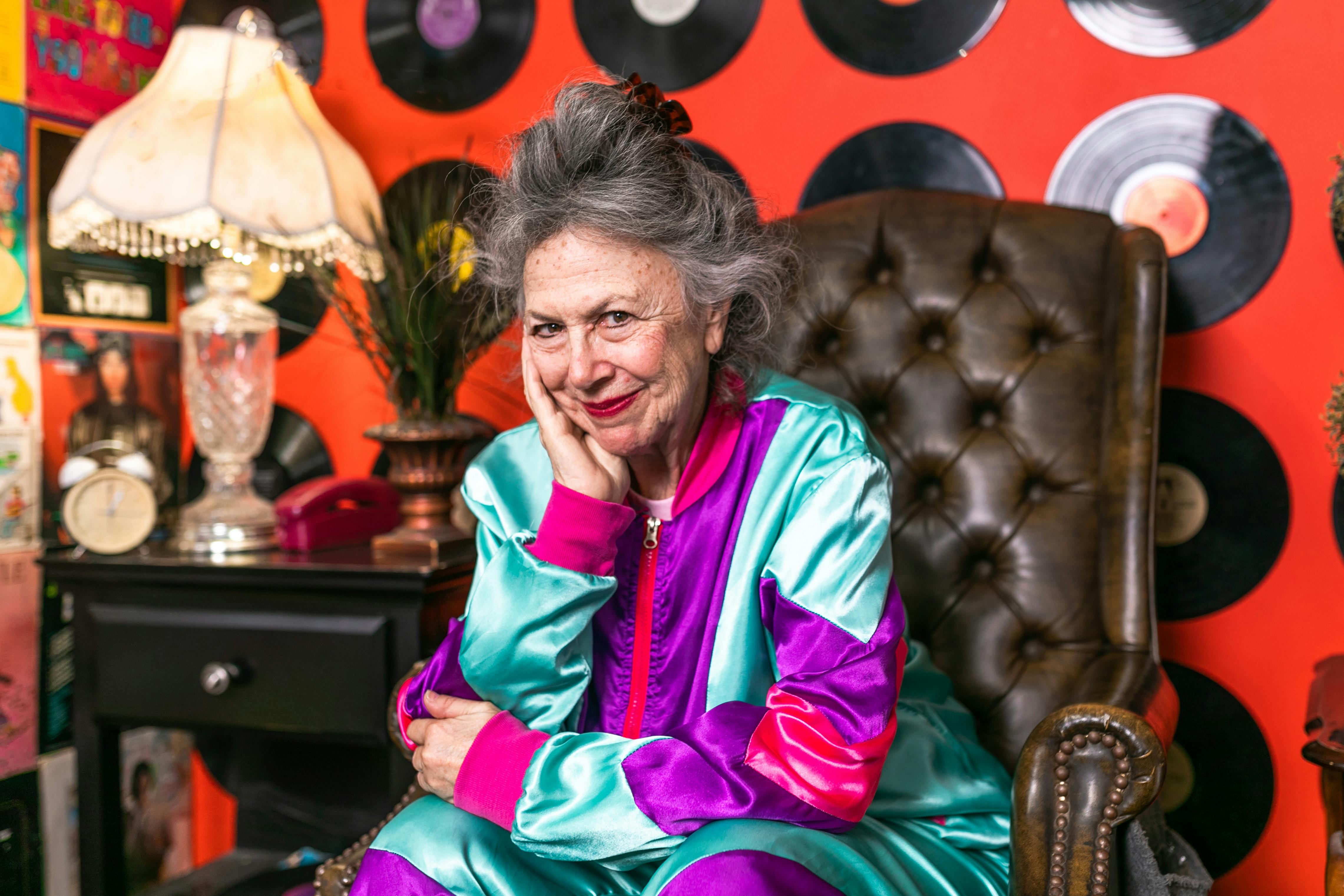 smiling elderly woman sitting on brown leather chair